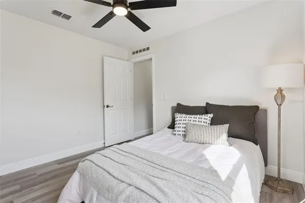 a bedroom with a bed and a ceiling fan