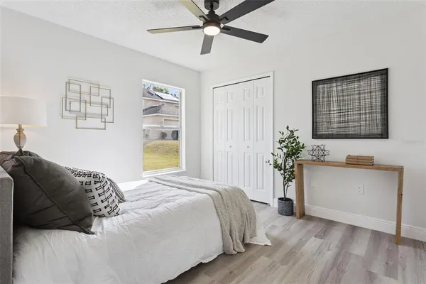 a bedroom with a bed and a potted plant