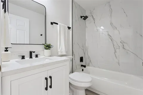 a bathroom with a sink a toilet and a bathtub