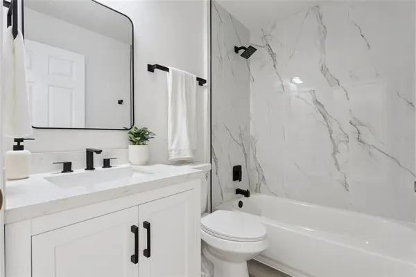 a bathroom with a sink a toilet and a bathtub