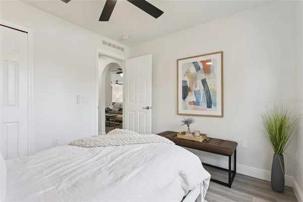 a bedroom with a bed and a potted plant