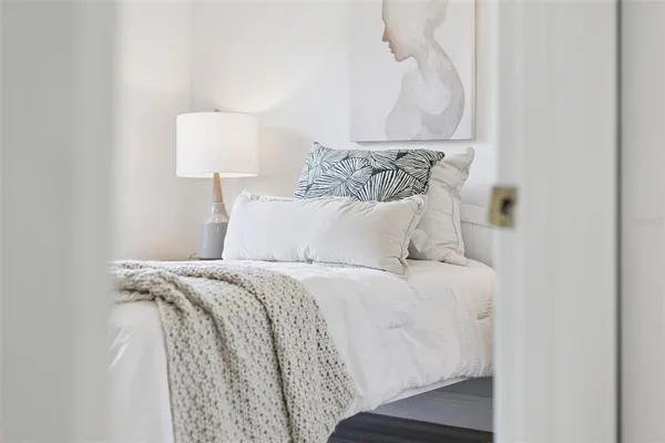 a large bed sitting in a bedroom next to a white wall