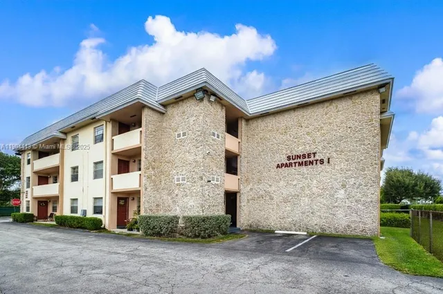 a front view of a building with a yard