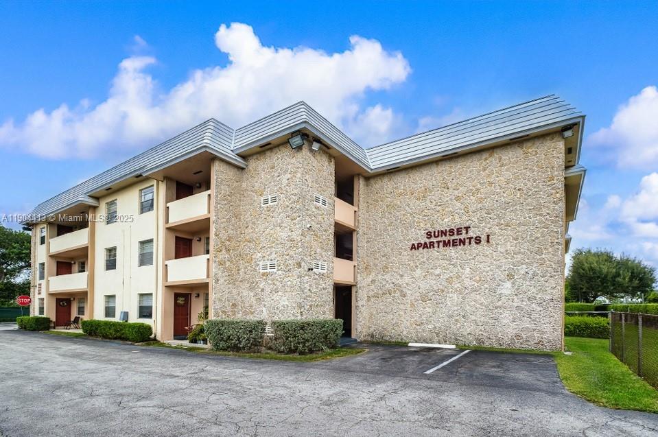 a front view of a building with a yard