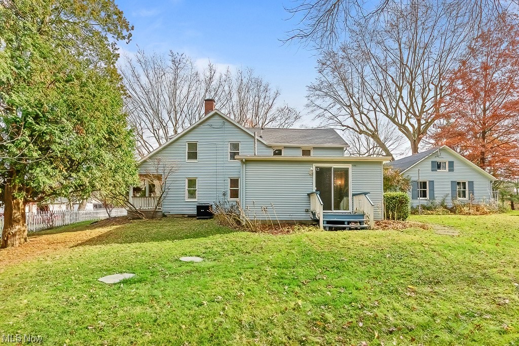 22121 Buck Road Alliance, OH 44601 - Photo 13 of 34 Rear view of house featuring a yard