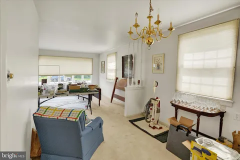a view of a dining room with furniture and a chandelier