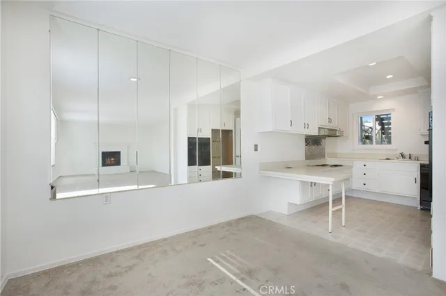 a large white kitchen with a stove a sink and a refrigerator