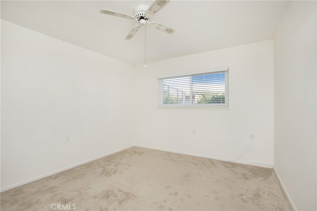 2137 Ronda Granada, Unit A Laguna Woods, CA 92637 - Photo 10 of 16 an empty room with a window and a fan
