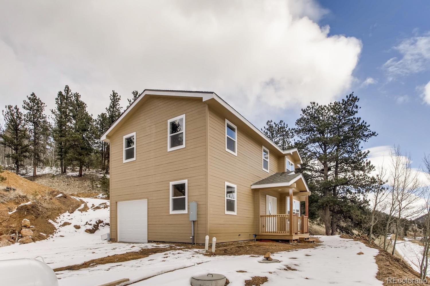 217 Bishop Road Bailey, CO 80421 - Photo 1 of 15 a front view of a house with a space