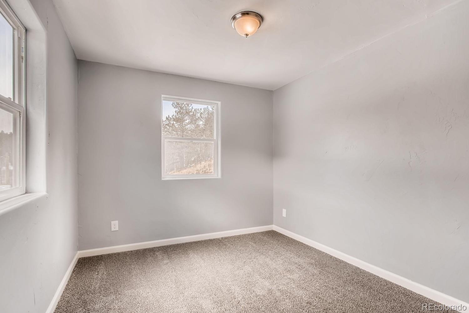 217 Bishop Road Bailey, CO 80421 - Photo 11 of 15 an empty room with a window
