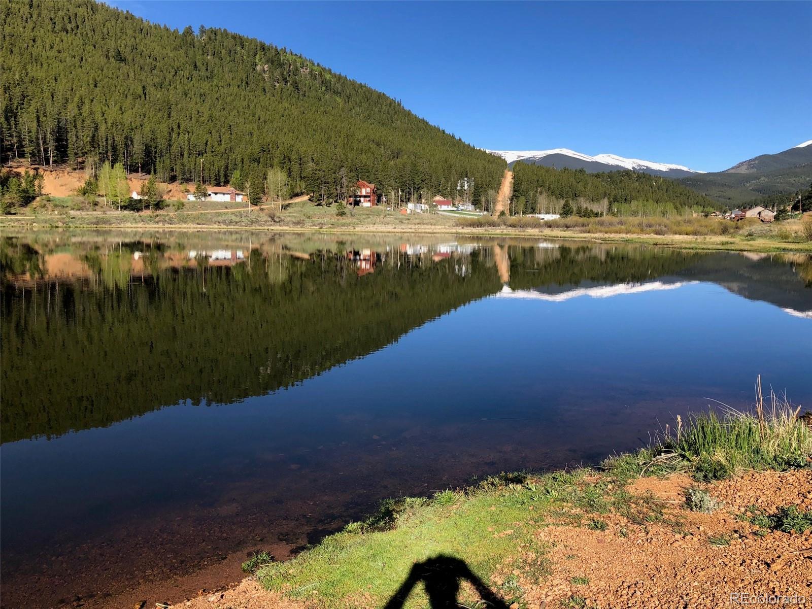 217 Bishop Road Bailey, CO 80421 - Photo 14 of 15 a view of a lake with a mountain in the background