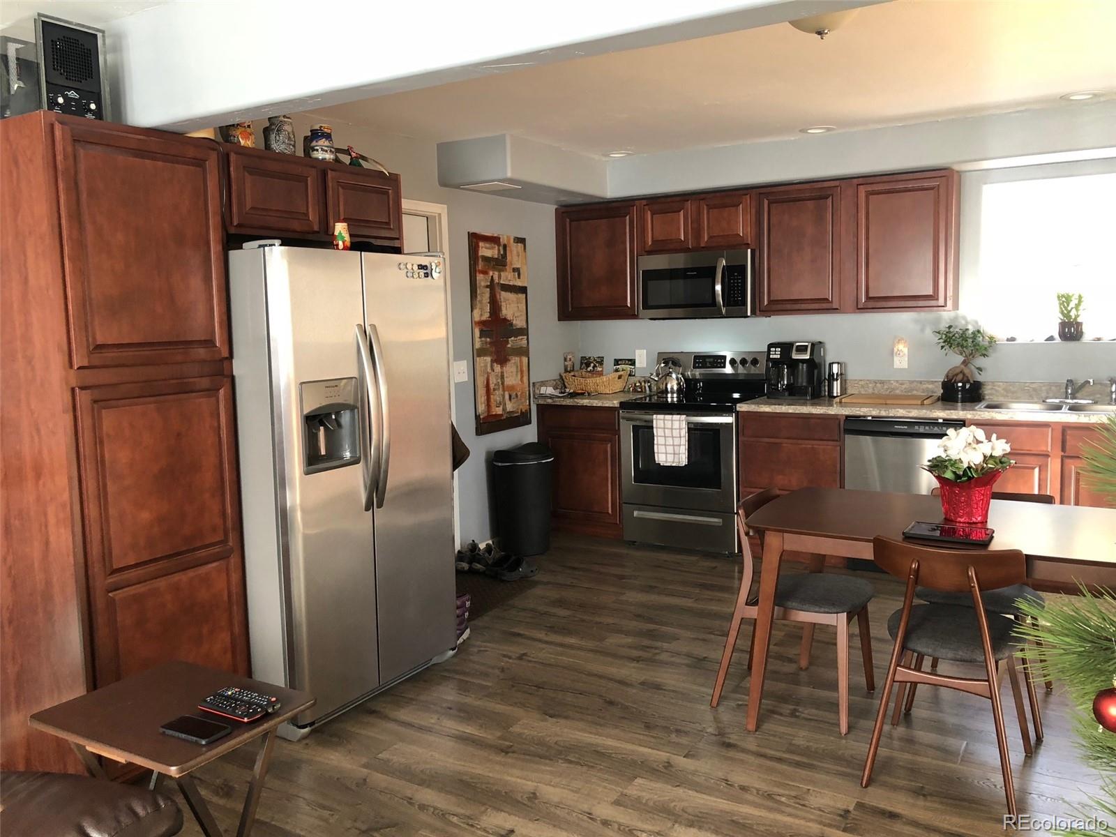 217 Bishop Road Bailey, CO 80421 - Photo 3 of 15 a kitchen with granite countertop a refrigerator stove top oven and sink