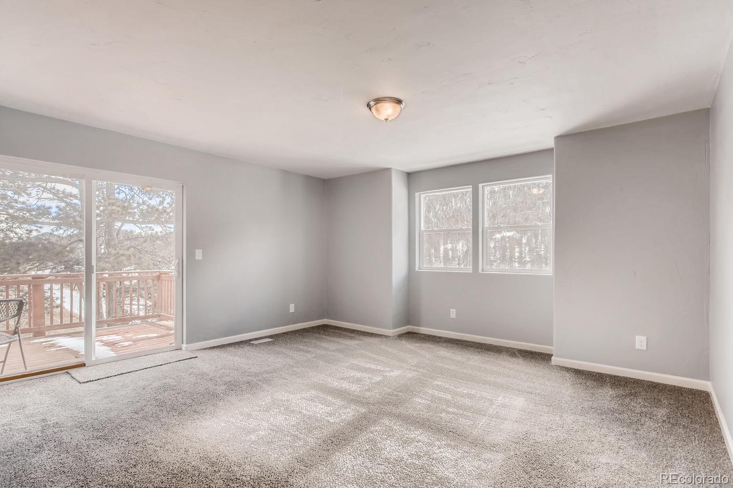 217 Bishop Road Bailey, CO 80421 - Photo 7 of 15 a view of an empty room with glass door