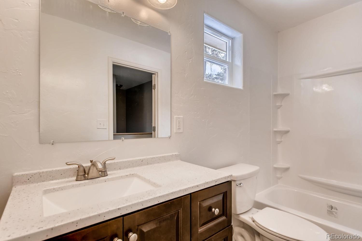 217 Bishop Road Bailey, CO 80421 - Photo 8 of 15 a bathroom with a sink toilet vanity and tub