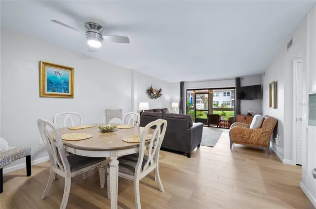 a view of a dining room with furniture window and wooden floor