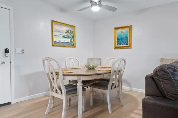 a view of a dining room with furniture and wooden floor
