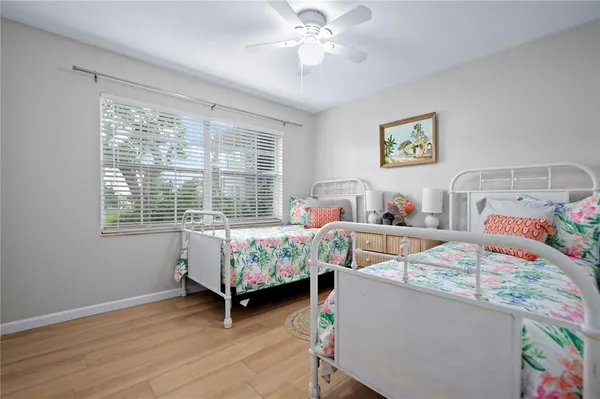 a bedroom with furniture and a wooden floor