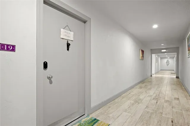 a view of a hallway with wooden floor