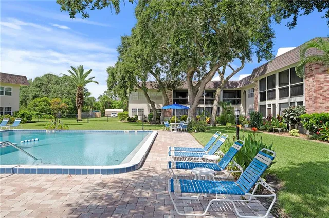 a view of a house with swimming pool and sitting area