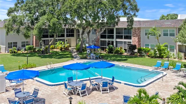 a view of swimming pool with outdoor seating and yard
