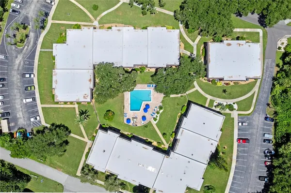 an aerial view of a house with a garden and a water fountain