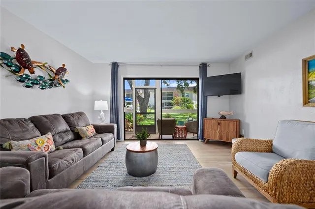 a living room with furniture and a potted plant