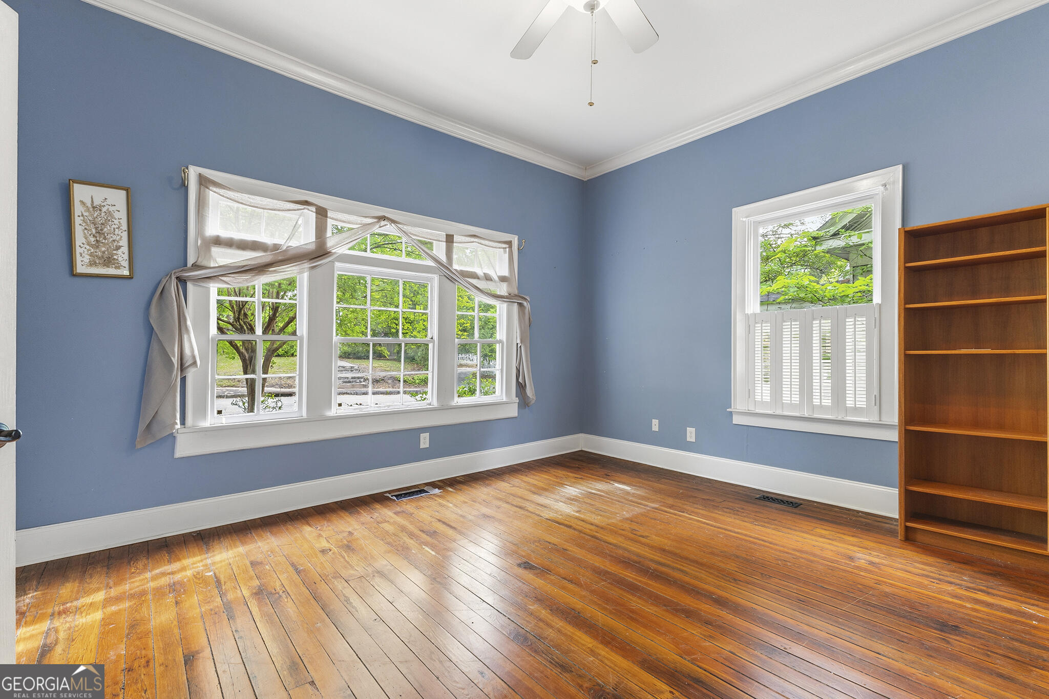 1469 Chestnut Street Macon, GA 31201 - Photo 7 of 26 a view of an empty room with a window and wooden floor