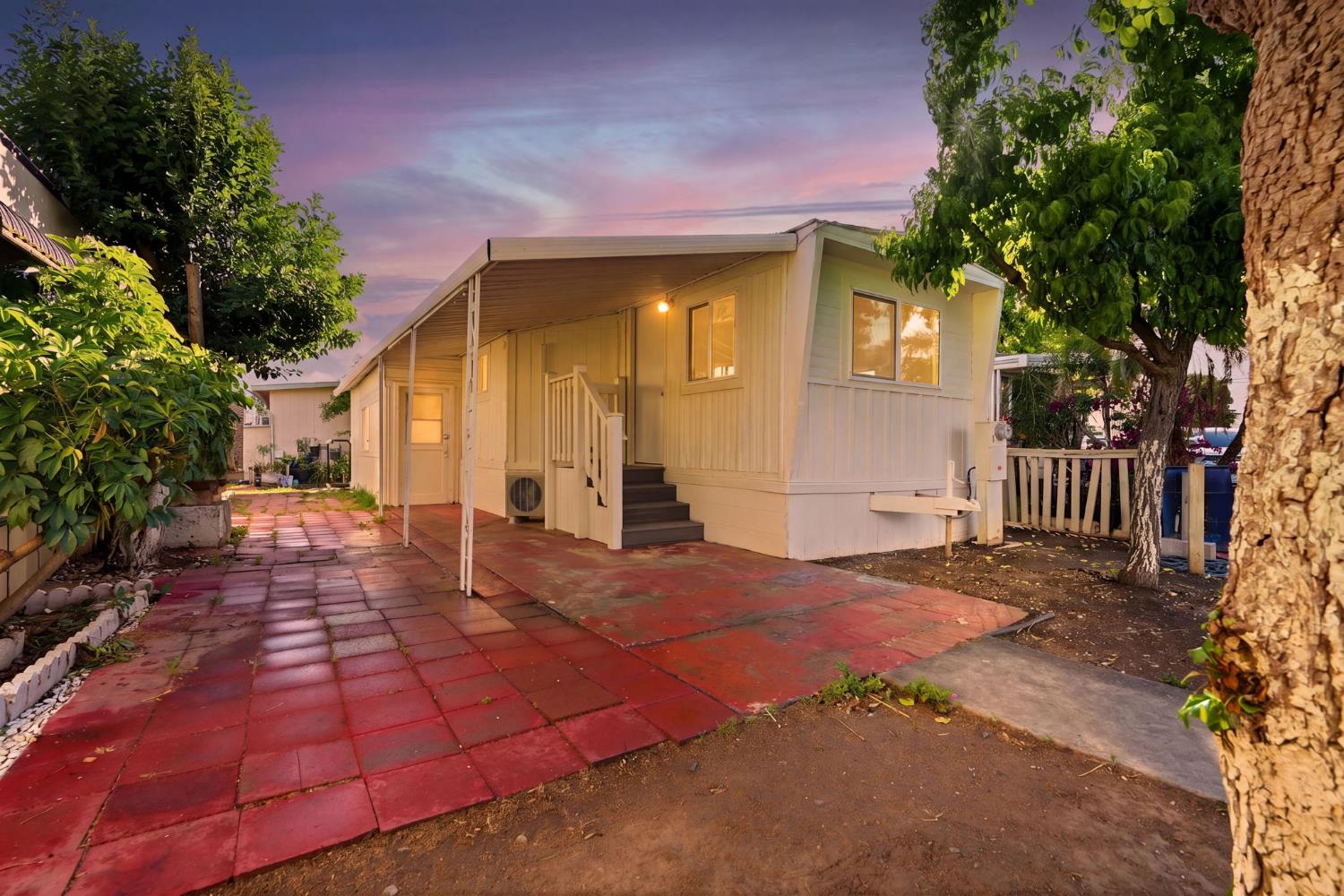 715 South Kaweah Avenue, Unit 9 Exeter, CA 93221 - Photo 1 of 15 a view of backyard with large trees and plants