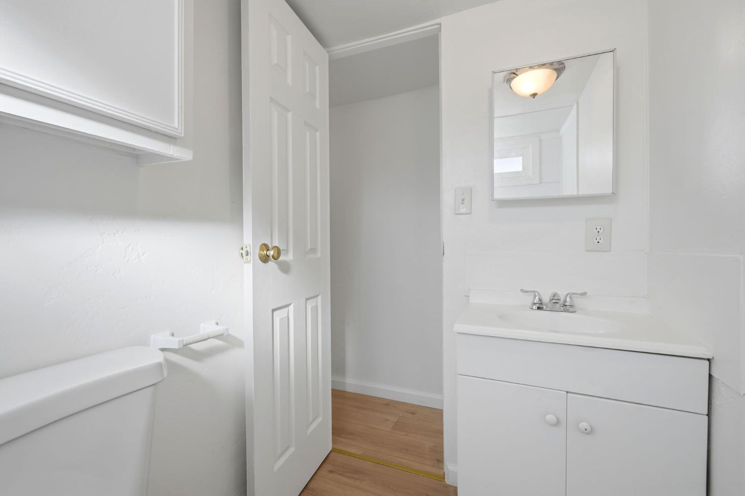 715 South Kaweah Avenue, Unit 9 Exeter, CA 93221 - Photo 11 of 15 a bathroom with a sink a toilet and a mirror