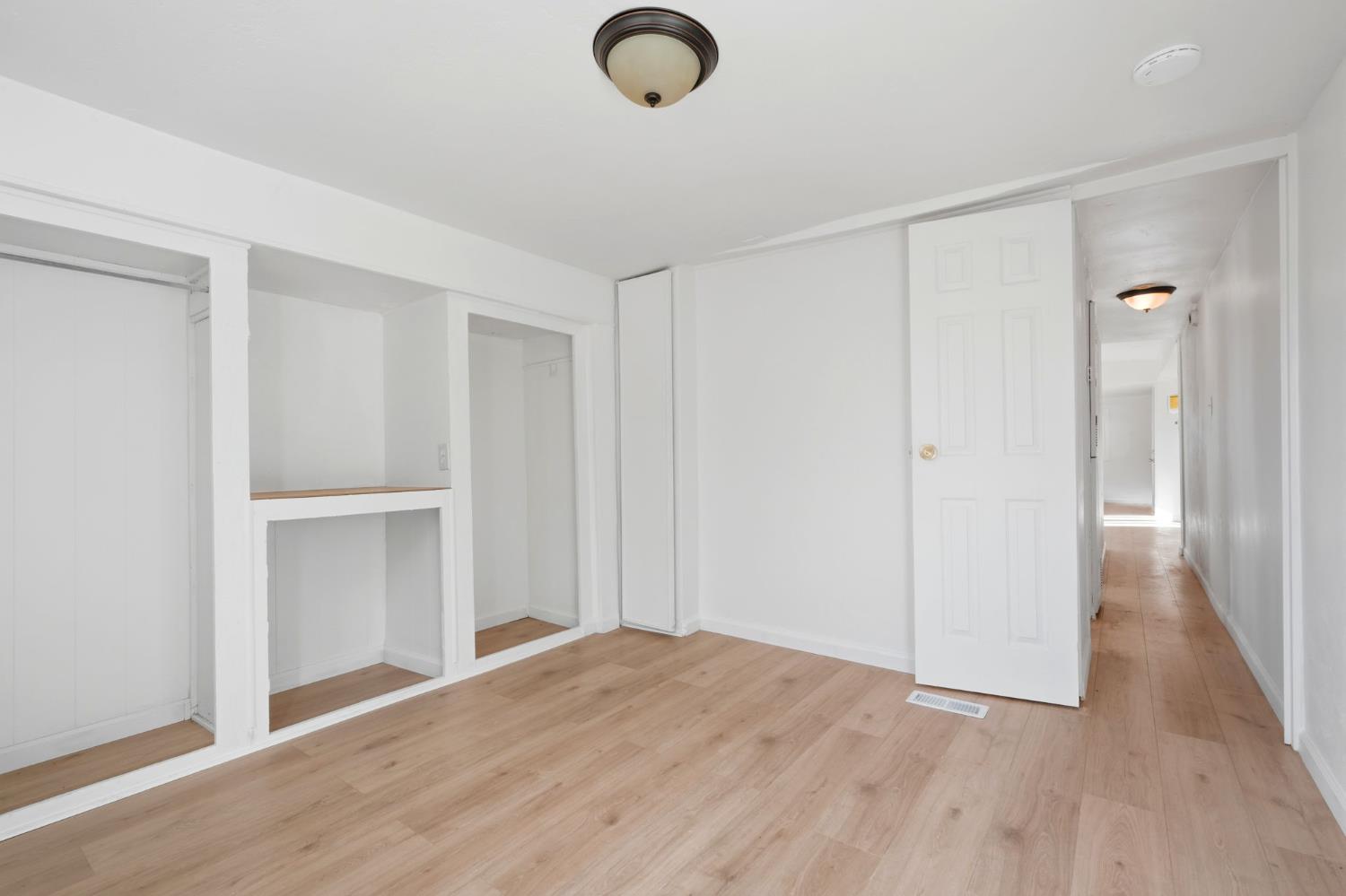 715 South Kaweah Avenue, Unit 9 Exeter, CA 93221 - Photo 13 of 15 a view of empty room with wooden floor