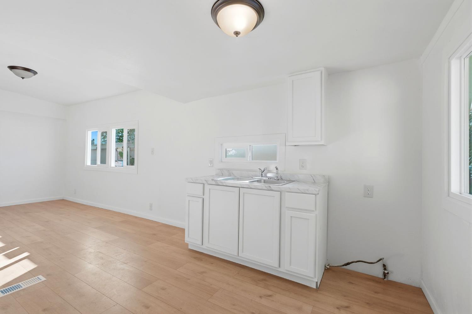 715 South Kaweah Avenue, Unit 9 Exeter, CA 93221 - Photo 7 of 15 a room with a sink cabinets and utility room