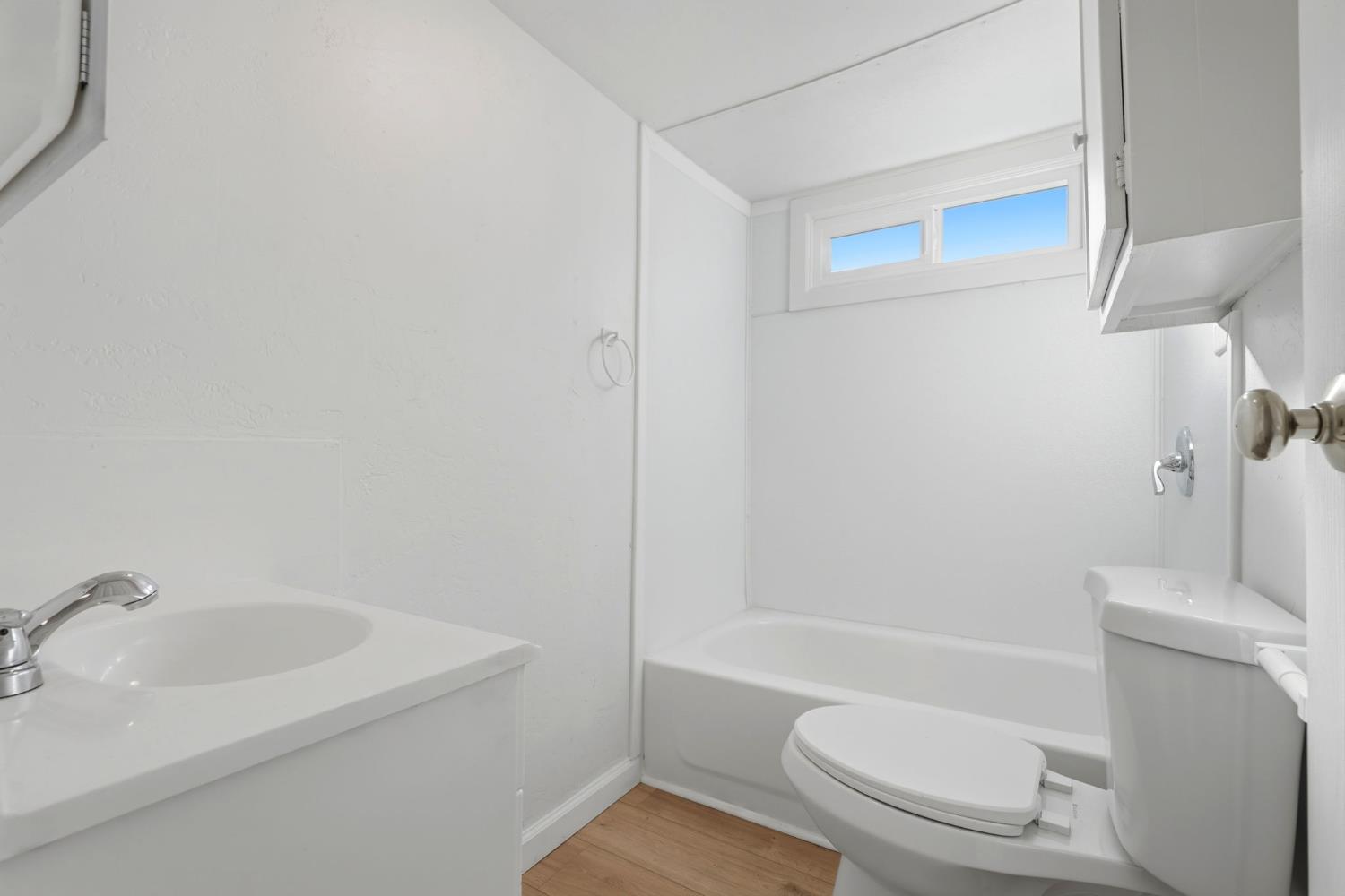 715 South Kaweah Avenue, Unit 9 Exeter, CA 93221 - Photo 10 of 15 a bathroom with a toilet a sink and bathtub