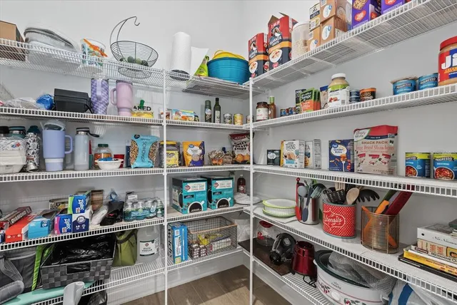 a kitchen with stainless steel appliances granite countertop a refrigerator stove a sink and dishwasher with wooden floor