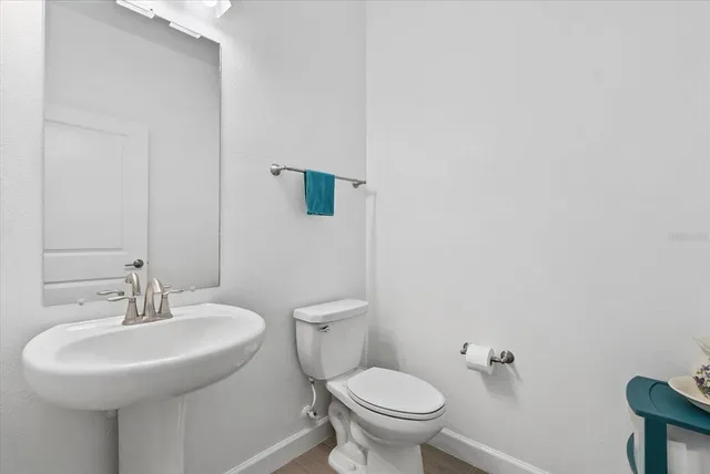 a table with a vase and flowers on it