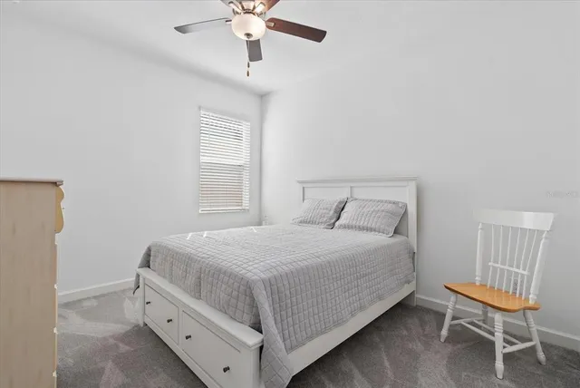 a bathroom with a toilet a sink a mirror a bathtub and vanity