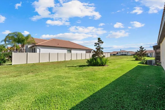 an aerial view of a house with outdoor space and a lake view