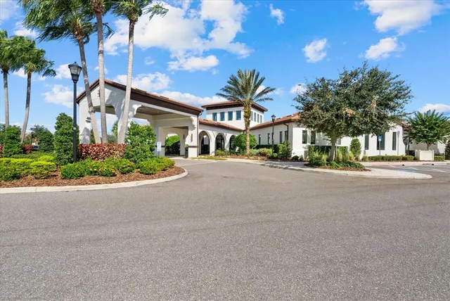 a sign of golf club on a wall under a tree