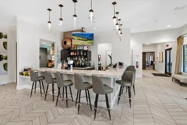 a living room with a couch and paintings on the wall