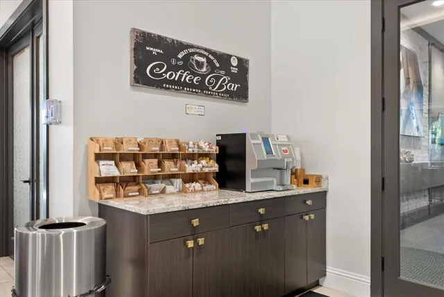 a dining room with furniture and a chandelier fan