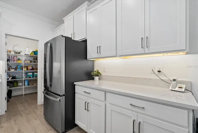 a kitchen with a refrigerator and cabinets