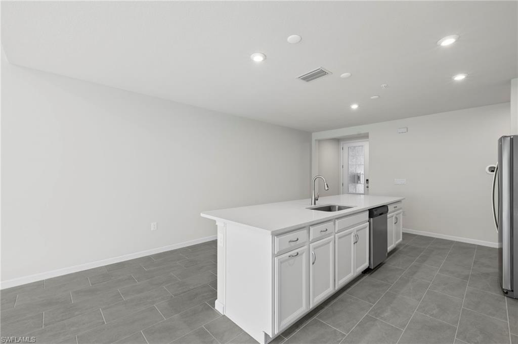 4664 Arboretum Circle, Unit 102 Naples, FL 34112 - Photo 24 of 39 a kitchen with a sink and a stove top oven