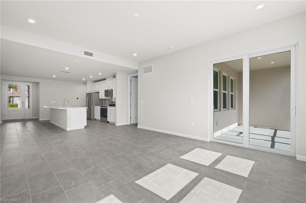 4664 Arboretum Circle, Unit 102 Naples, FL 34112 - Photo 27 of 39 a view of an empty room with a window