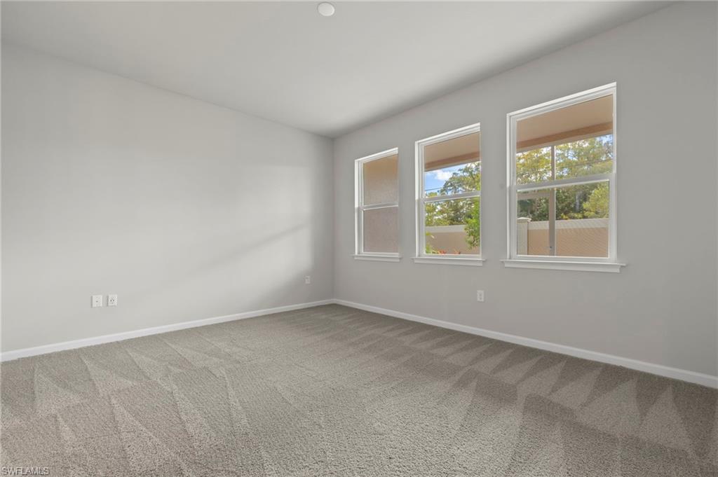 4664 Arboretum Circle, Unit 102 Naples, FL 34112 - Photo 29 of 39 an empty room with windows