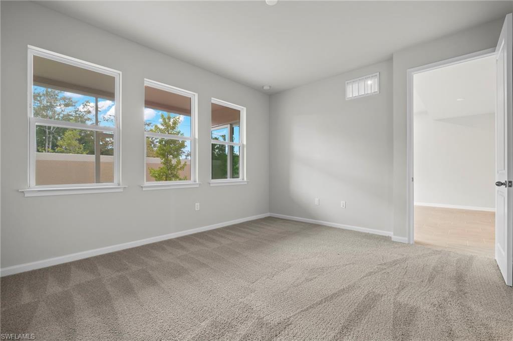 4664 Arboretum Circle, Unit 102 Naples, FL 34112 - Photo 30 of 39 an empty room with windows