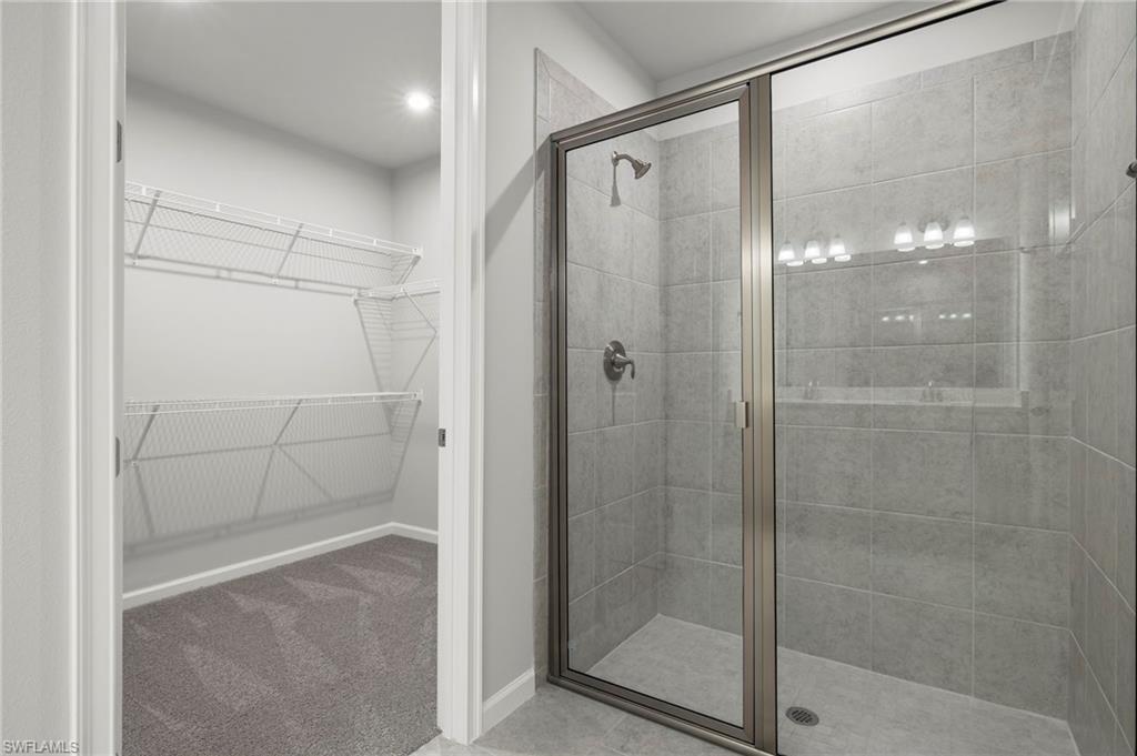 4664 Arboretum Circle, Unit 102 Naples, FL 34112 - Photo 33 of 39 a bathroom with a glass shower door