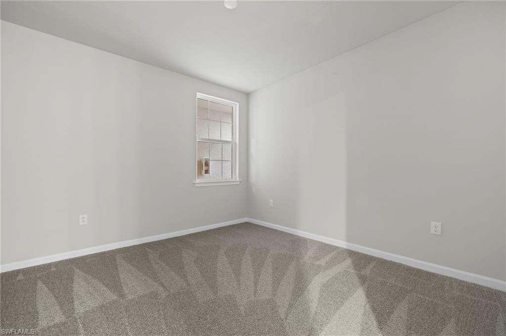 4664 Arboretum Circle, Unit 102 Naples, FL 34112 - Photo 34 of 39 an empty room with a window