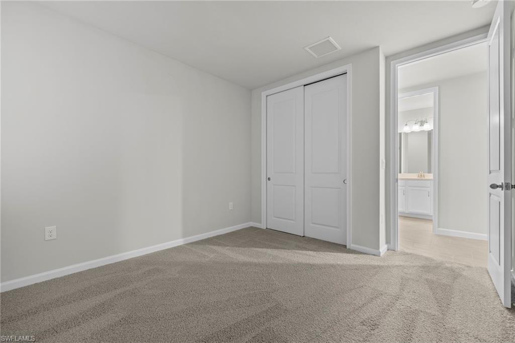 4664 Arboretum Circle, Unit 102 Naples, FL 34112 - Photo 35 of 39 an empty room with closet area