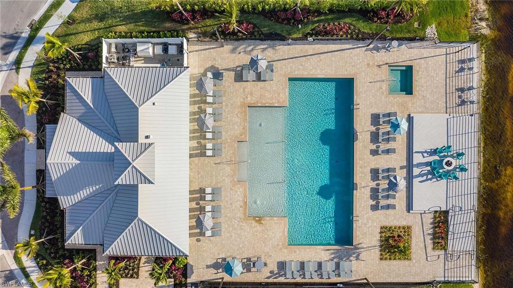 4664 Arboretum Circle, Unit 102 Naples, FL 34112 - Photo 7 of 39 a view of a brick house with many windows