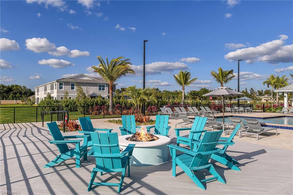 4664 Arboretum Circle, Unit 102 Naples, FL 34112 - Photo 9 of 39 a view of a chairs and table in patio with a lake view