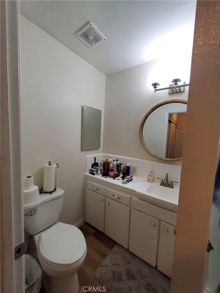 728 Cedar Avenue, Unit 29 Long Beach, CA 90813 - Photo 14 of 14 a bathroom with a toilet sink and mirror